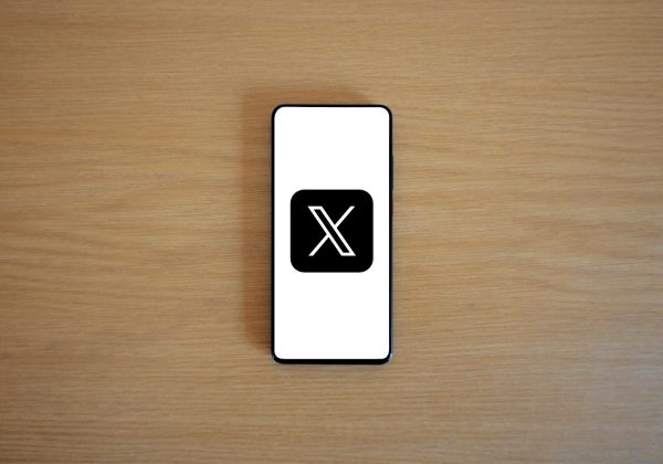 The X icon is displayed on the mobile screen on a table